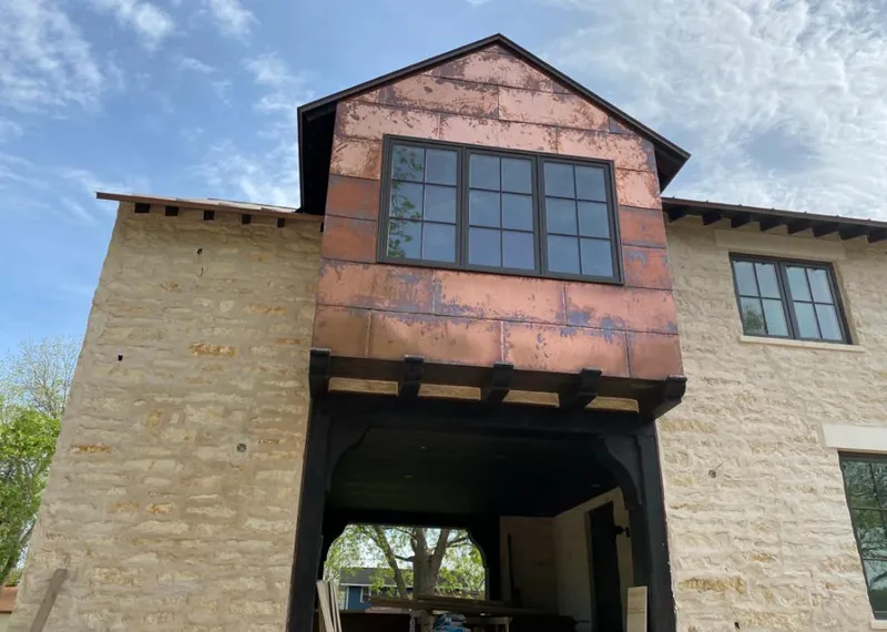 Copper metal panel facade on a stone building for Skylight Installation in Anderson Creek